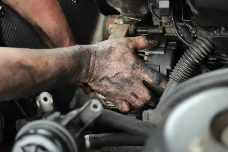 Hands working on an engine bay