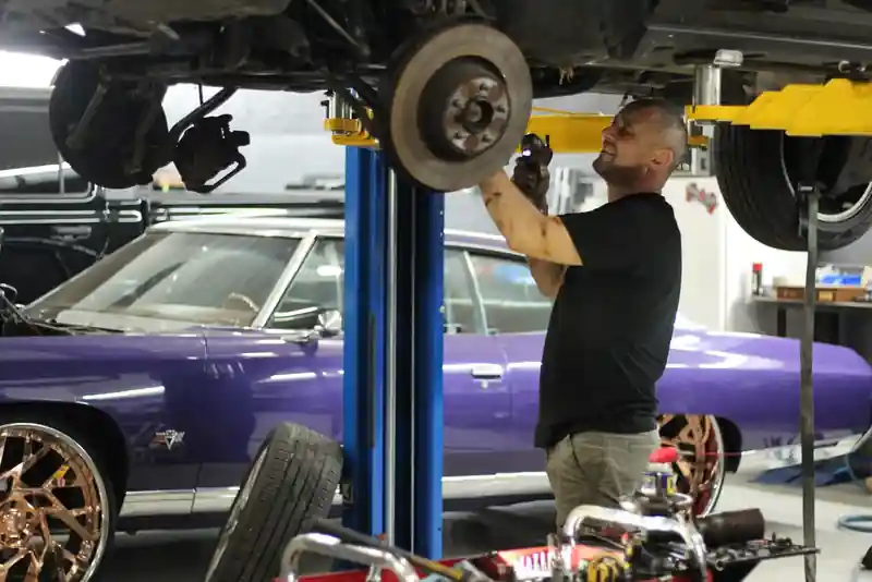 Suspension repair on a car lift at Top Car Performance